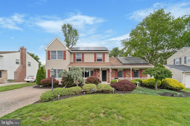 14 Yorkshire Rd, Hamilton, NJ 08610 - traditional home featuring covered porch, solar panels, a front yard, and brick siding