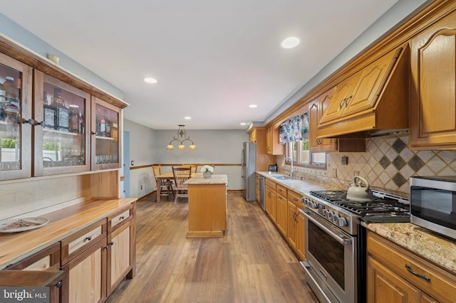 14 Yorkshire Rd, Hamilton, NJ 08610 - kitchen featuring stainless steel appliances, a sink, dark wood finished floors, decorative backsplash, and a kitchen island