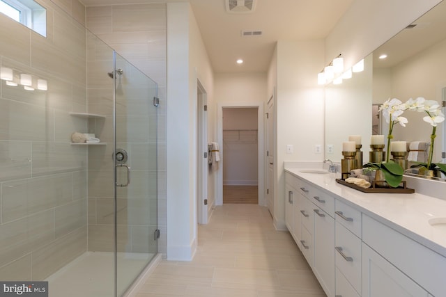 22047 Heartwood Cir, Lewes, DE 19958 - bathroom featuring double vanity, a stall shower, recessed lighting, a walk in closet, and baseboards