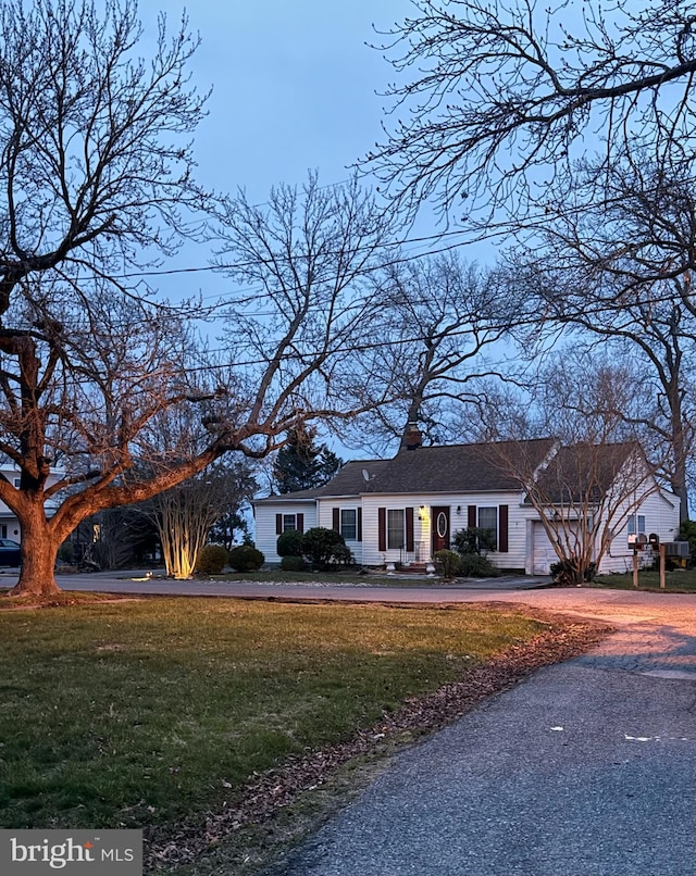 5227 Al Jones Dr, Shady Side, MD 20764 - single story home with an attached garage, a front yard, driveway, and a chimney