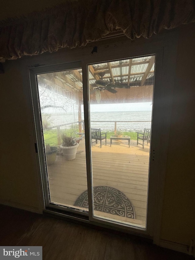 5227 Al Jones Dr, Shady Side, MD 20764 - doorway with healthy amount of natural light, dark wood-style flooring, and a water view