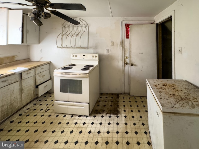 1228 Pacific Ave, Bristol, PA 19007 - kitchen with white electric stove, light floors, ceiling fan, and light countertops