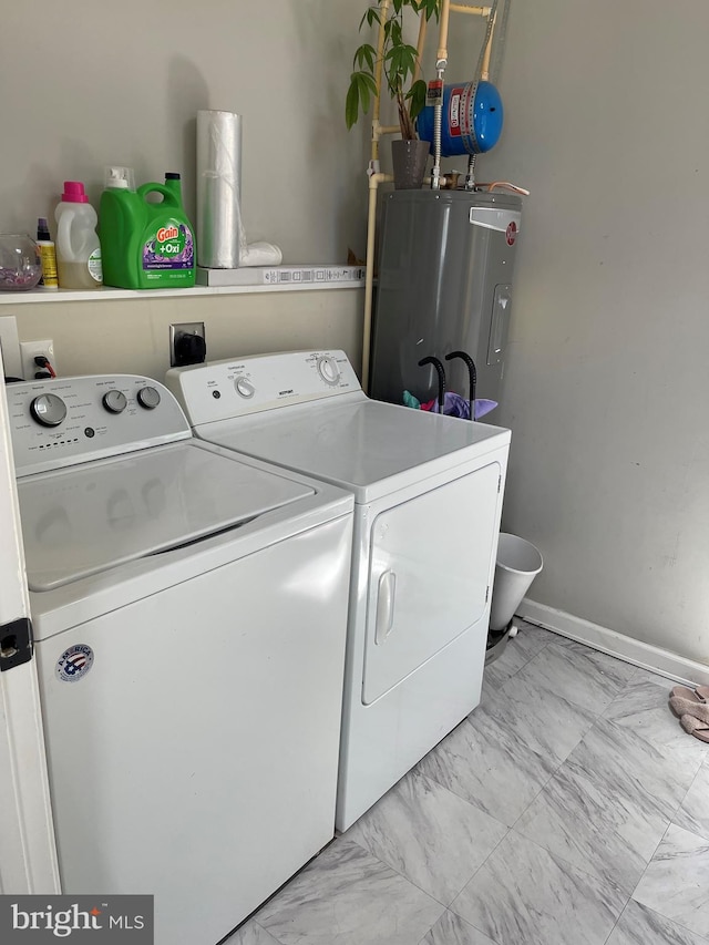 1604 Manning Rd, Glen Burnie, MD 21061 - washroom featuring washing machine and dryer, electric water heater, and light marble finish flooring