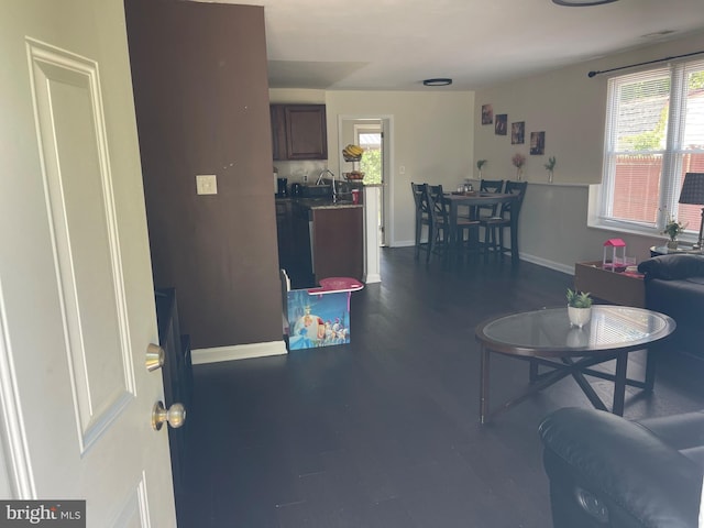 1604 Manning Rd, Glen Burnie, MD 21061 - living area featuring healthy amount of natural light, baseboards, and dark wood-style flooring