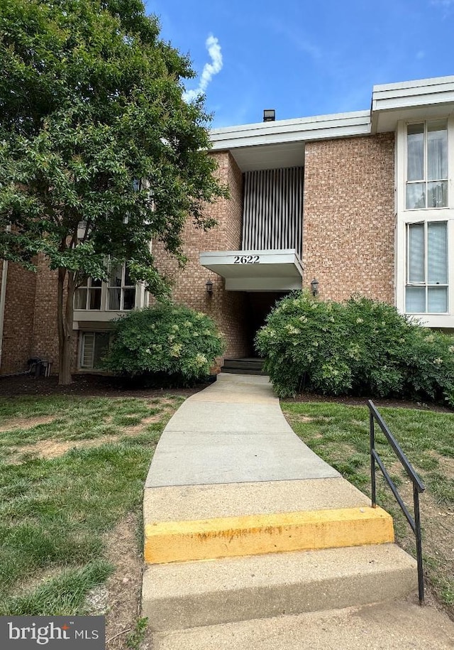 2622 Wagon Dr Unit 319, Alexandria, VA 22303 - property entrance with a lawn and brick siding