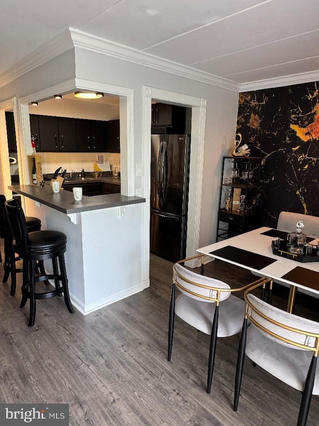 2622 Wagon Dr Unit 319, Alexandria, VA 22303 - kitchen with freestanding refrigerator, dark cabinetry, dark countertops, dark wood-type flooring, and ornamental molding