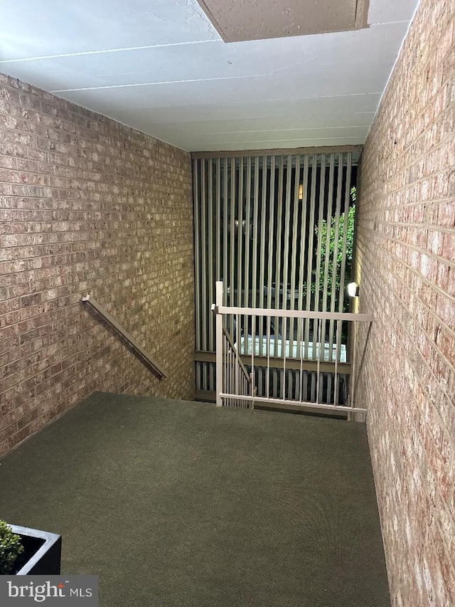 2622 Wagon Dr Unit 319, Alexandria, VA 22303 - basement featuring carpet floors and brick wall
