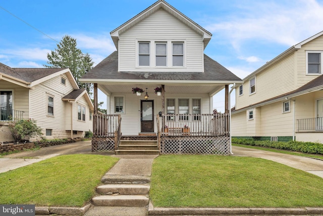 122 E Pine St, Audubon, NJ 08106 - view of front of property with covered porch, roof with shingles, and a front lawn