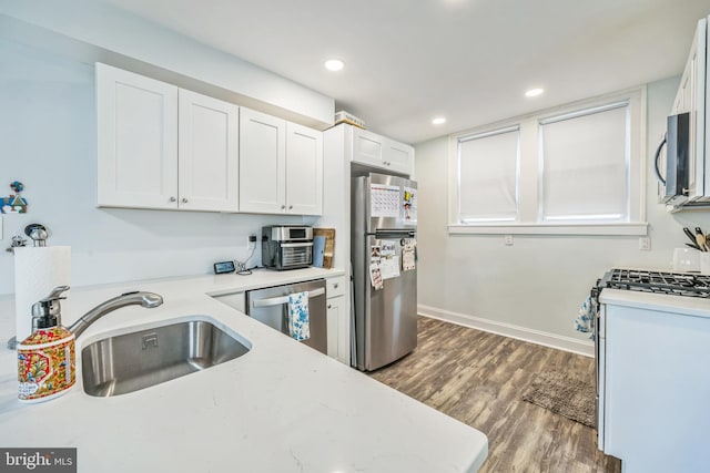 122 E Pine St, Audubon, NJ 08106 - kitchen featuring stainless steel appliances, a sink, wood finished floors, white cabinetry, and recessed lighting