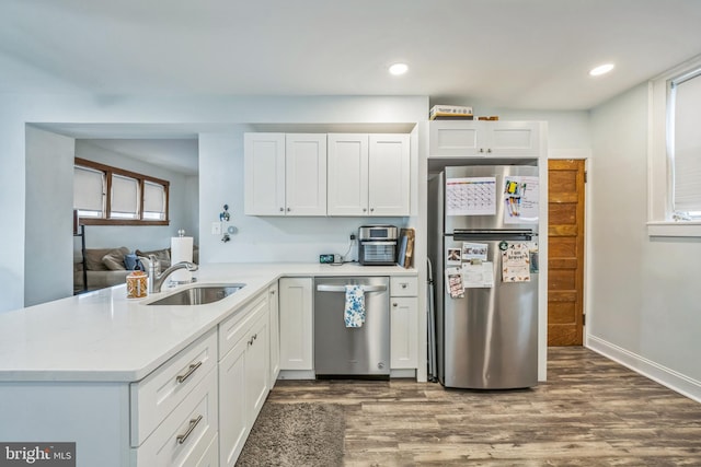122 E Pine St, Audubon, NJ 08106 - kitchen featuring appliances with stainless steel finishes, a sink, dark wood-style floors, light countertops, and recessed lighting