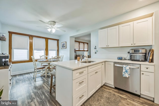 122 E Pine St, Audubon, NJ 08106 - kitchen featuring stainless steel dishwasher, a sink, a ceiling fan, dark wood-type flooring, and a peninsula