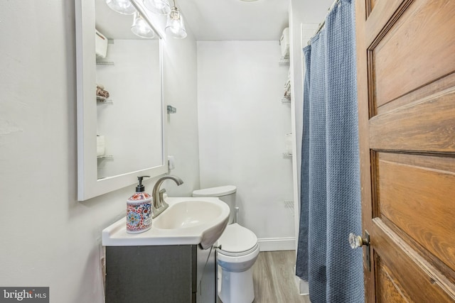 122 E Pine St, Audubon, NJ 08106 - bathroom featuring toilet, vanity, wood finished floors, a shower with shower curtain, and baseboards