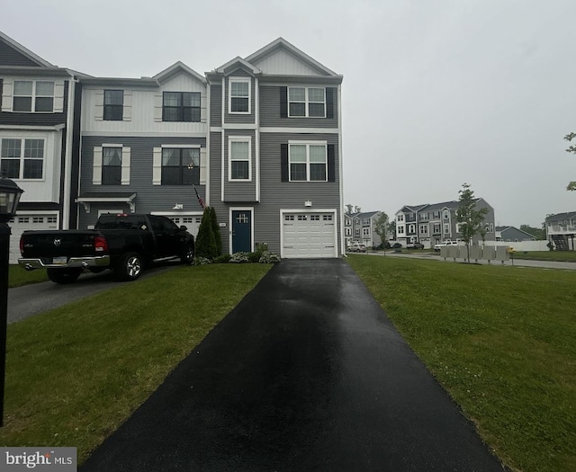 144 Overlook Dr, Hanover, PA 17331 - view of front facade with driveway, an attached garage, a front yard, and board and batten siding