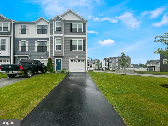 144 Overlook Dr, Hanover, PA 17331 - view of front facade with an attached garage, asphalt driveway, a residential view, board and batten siding, and a front yard
