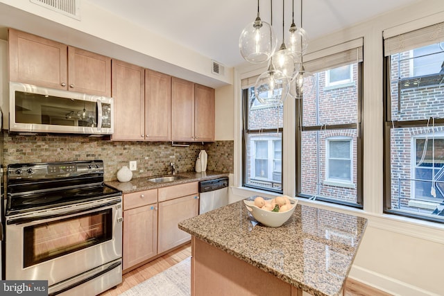 1858 California St NW Unit 20, Washington, DC 20009 - kitchen featuring stainless steel appliances, light brown cabinetry, a sink, and decorative backsplash