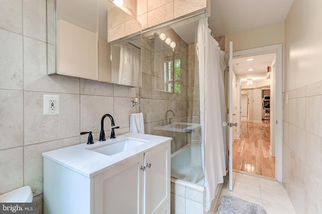 1858 California St NW Unit 20, Washington, DC 20009 - full bathroom featuring tile walls, vanity, toilet, and tile patterned flooring