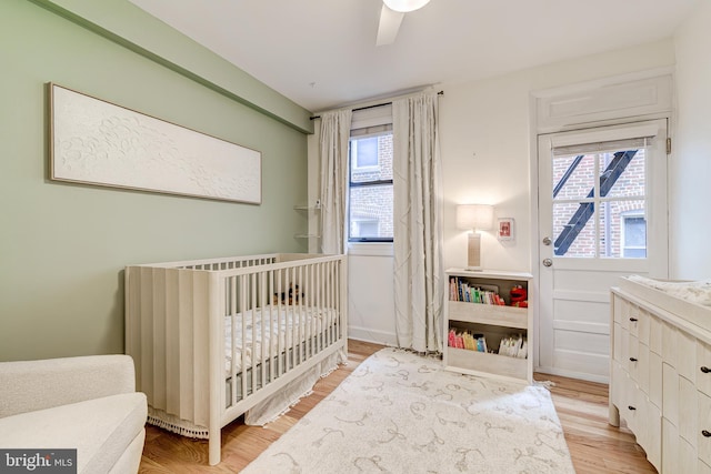 1858 California St NW Unit 20, Washington, DC 20009 - bedroom featuring a nursery area, light wood-type flooring, and ceiling fan