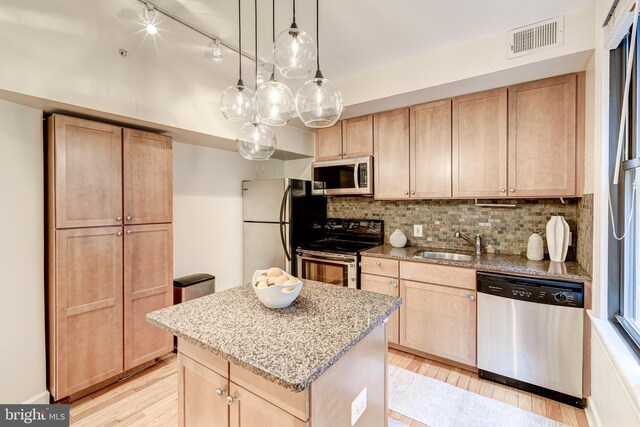 1858 California St NW Unit 20, Washington, DC 20009 - kitchen with appliances with stainless steel finishes, a sink, light brown cabinets, and light wood finished floors