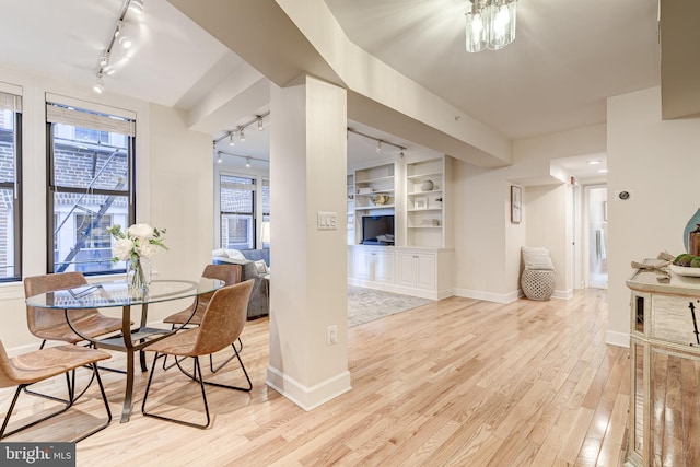 1858 California St NW Unit 20, Washington, DC 20009 - dining area featuring track lighting, light wood finished floors, baseboards, and built in shelves