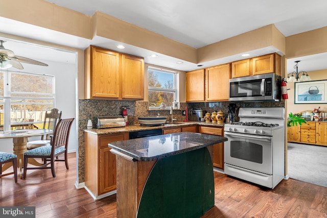 1 Winterberry Pl, Clayton, NJ 08312 - kitchen featuring stainless steel microwave, white range with gas cooktop, dark wood-style floors, backsplash, and a kitchen island