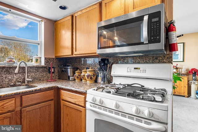 1 Winterberry Pl, Clayton, NJ 08312 - kitchen featuring stainless steel microwave, white range with gas stovetop, a sink, decorative backsplash, and carpet floors