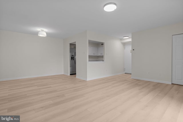 45104 Delaire Landing Rd Unit 104, Philadelphia, PA 19114 - basement with light wood-style floors, baseboards, and stainless steel fridge
