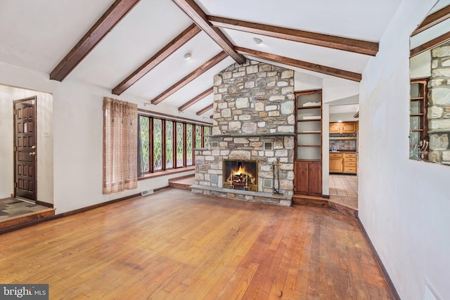 1685 E Willow Grove Ave, Glenside, PA 19038 - unfurnished living room with wood-type flooring, a fireplace, beamed ceiling, high vaulted ceiling, and baseboards