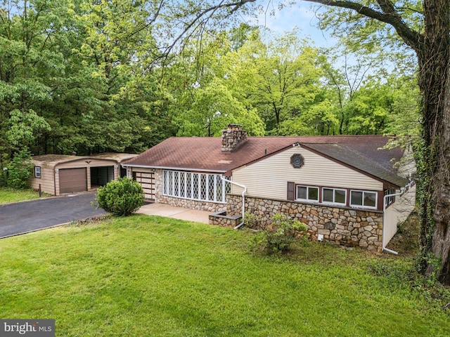 1685 E Willow Grove Ave, Glenside, PA 19038 - view of front facade with stone siding, a chimney, a front lawn, an outdoor structure, and a garage