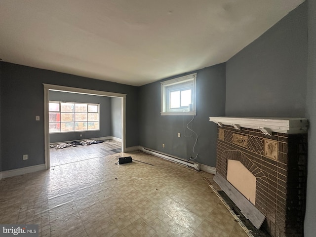1318 E Luzerne St, Philadelphia, PA 19124 - unfurnished living room featuring a baseboard radiator, a fireplace, and baseboards