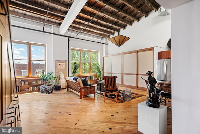 3132 E Thompson St Unit 2C, Philadelphia, PA 19134 - living room featuring wooden ceiling with exposed beams, light wood-type flooring, and a towering ceiling