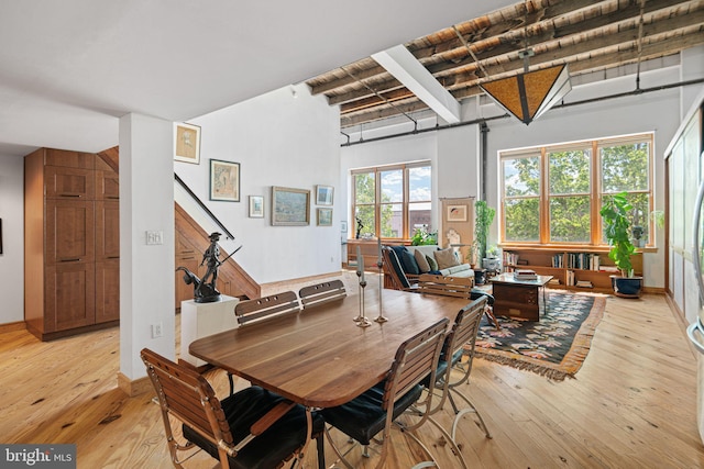 3132 E Thompson St Unit 2C, Philadelphia, PA 19134 - dining space with light wood-type flooring, beam ceiling, and stairs
