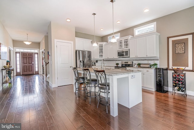 6039 Union Tunnel Dr, Harrisburg, PA 17111 - kitchen featuring appliances with stainless steel finishes, beverage cooler, a center island with sink, plenty of natural light, and recessed lighting