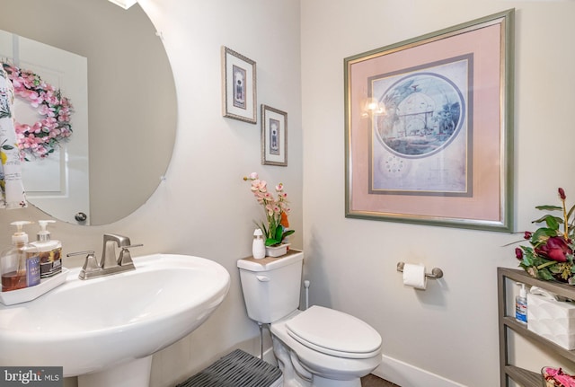 6039 Union Tunnel Dr, Harrisburg, PA 17111 - half bath with a sink, toilet, and baseboards