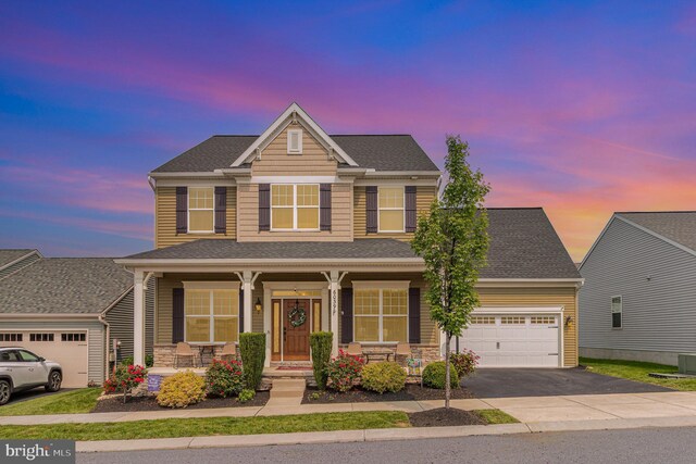 6039 Union Tunnel Dr, Harrisburg, PA 17111 - traditional-style home featuring a porch, driveway, a garage, roof with shingles, and stone siding
