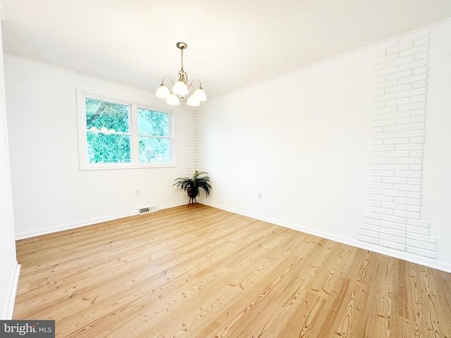 914 Townsend Blvd, Dover, DE 19901 - spare room featuring a chandelier, light wood finished floors, and baseboards