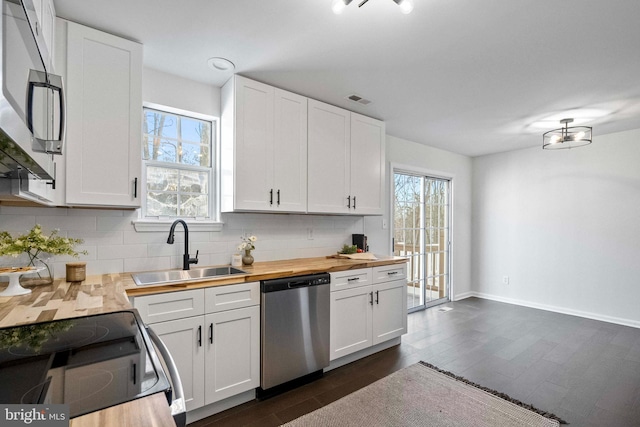 1123 Robin Hill Ct, Bel Air, MD 21015 - kitchen with stainless steel appliances, a sink, butcher block countertops, decorative backsplash, and white cabinets