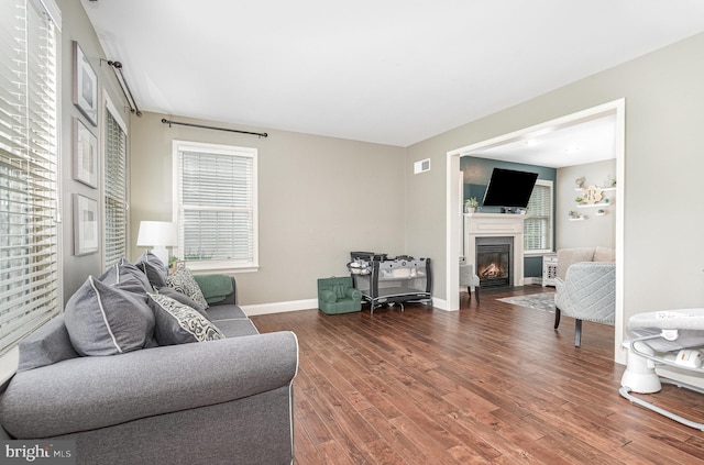 6202 Crofton Ct, Mechanicsburg, PA 17050 - living area with a glass covered fireplace, wood finished floors, and baseboards