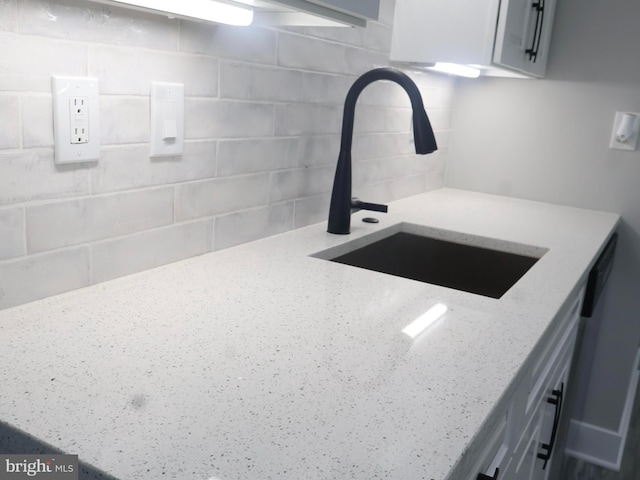 600 64th Ave, Capitol Heights, MD 20743 - kitchen view of a sink, backsplash, and light stone countertops