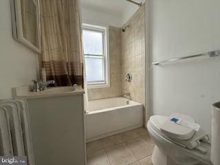 813 Sheridan St NW, Washington, DC 20011 - bathroom featuring toilet, tile patterned flooring, shower / tub combo, vanity, and radiator