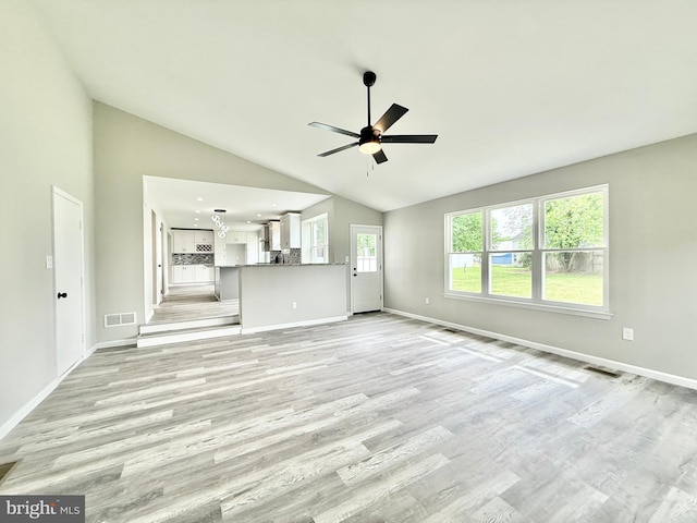 27 Chapel Cir, Sicklerville, NJ 08081 - unfurnished living room featuring a ceiling fan, vaulted ceiling, light wood-style floors, and baseboards
