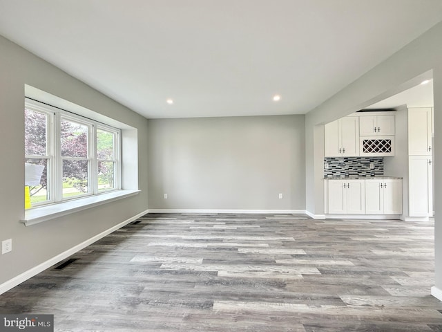 27 Chapel Cir, Sicklerville, NJ 08081 - unfurnished living room featuring light wood-type flooring, baseboards, recessed lighting, and a bar
