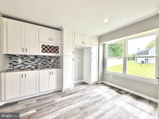 27 Chapel Cir, Sicklerville, NJ 08081 - kitchen with light wood-style flooring, decorative backsplash, white cabinets, baseboards, and dark stone counters