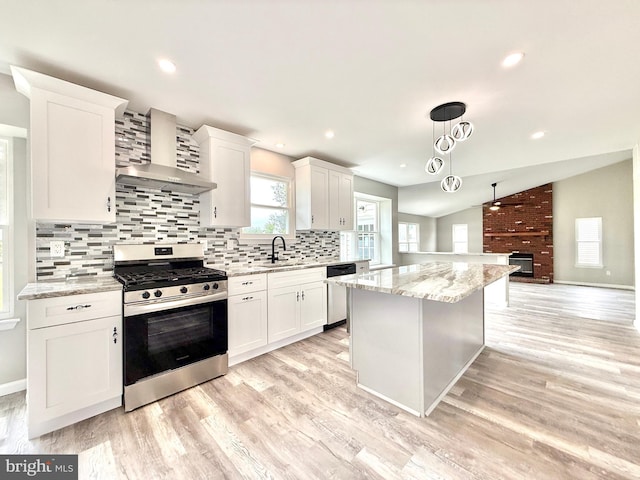 27 Chapel Cir, Sicklerville, NJ 08081 - kitchen with stainless steel appliances, wall chimney exhaust hood, a center island, a sink, and decorative backsplash