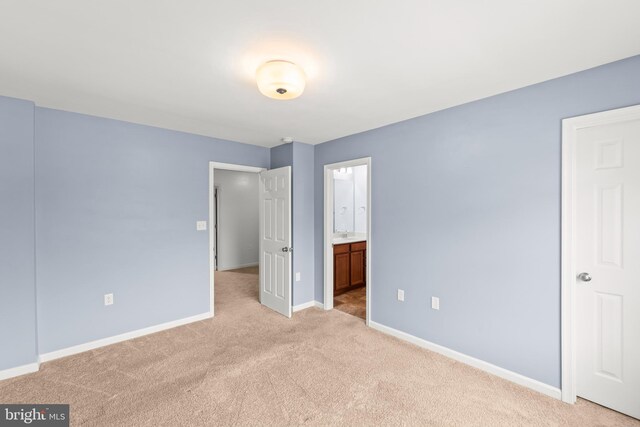 1312 S Kent St, Winchester, VA 22601 - unfurnished bedroom featuring light carpet, baseboards, and ensuite bath