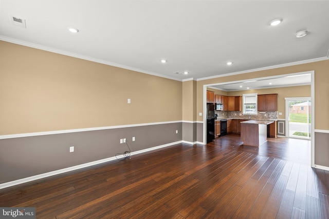 1312 S Kent St, Winchester, VA 22601 - unfurnished living room featuring dark wood-style flooring, baseboards, crown molding, and recessed lighting