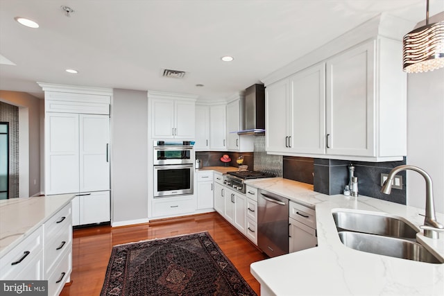1830 Fountain Dr Unit 1107, Reston, VA 20190 - kitchen with appliances with stainless steel finishes, wall chimney exhaust hood, recessed lighting, dark wood-style floors, and white cabinets