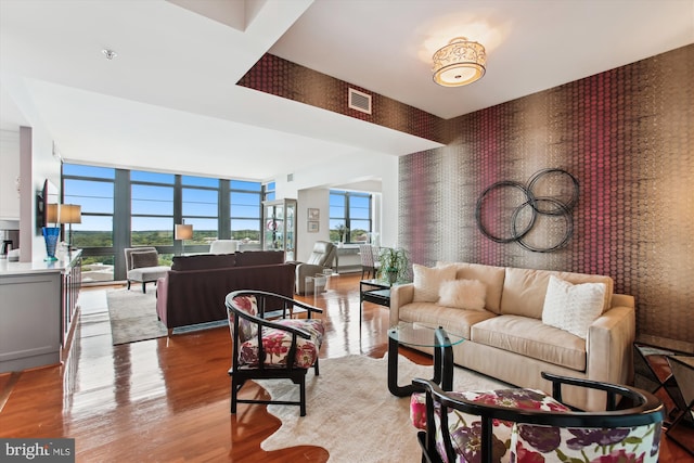 1830 Fountain Dr Unit 1107, Reston, VA 20190 - living area featuring wallpapered walls, wood finished floors, and a wall of windows