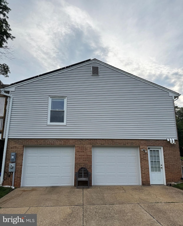 13 Montford Ct, Silver Spring, MD 20905 - view of property exterior featuring a garage, brick siding, and driveway