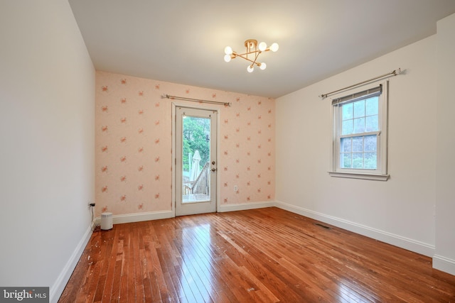 4108 Slater Ave, Baltimore, MD 21236 - unfurnished room with hardwood / wood-style flooring, a chandelier, healthy amount of natural light, baseboards, and wallpapered walls