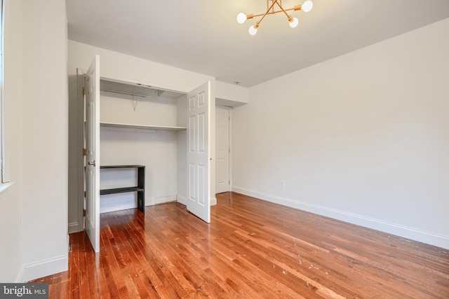 4108 Slater Ave, Baltimore, MD 21236 - unfurnished bedroom featuring hardwood / wood-style flooring, a chandelier, baseboards, and a closet